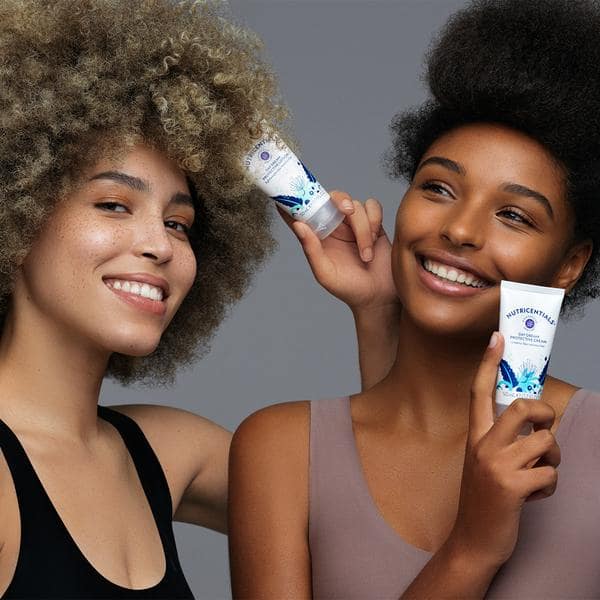 nu-skin-nutricentials-day-dream-protective-lotion-lightweight-moisturizer-women-hold-products-lifestyle-image-min