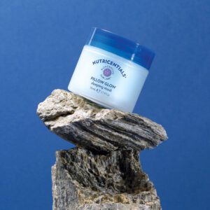 Nutricentials Pillow Glow Sleeping Mask on a rock